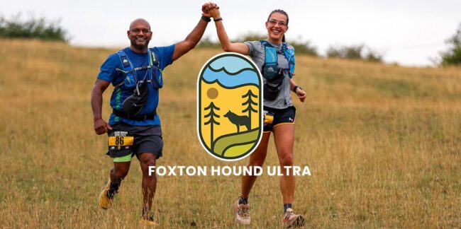 Two smiling runners holding hands, crossing a grassy finish line at Foxton Hound Ultra race.